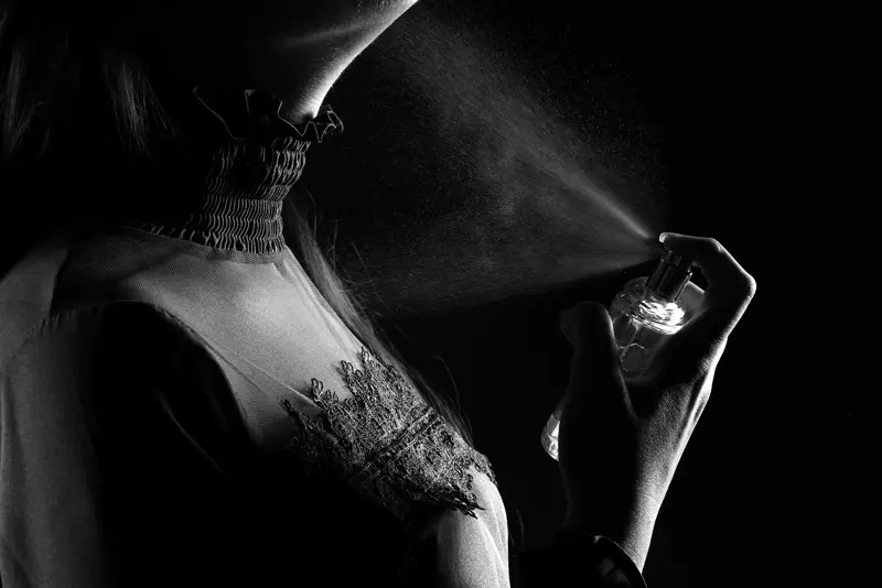 A fragrance worn — black and white portrait in falling mist