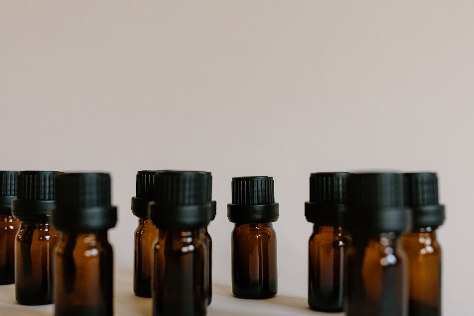 A row of dark amber vials against black — the trials that came before No. 01